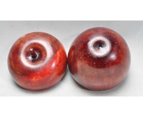 An antique tea caddy carved in exotic hardwood in the form of an apple. Measures 14cm tall.&nbsp;