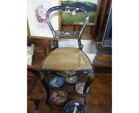 A Victorian Japanned and Mother of Pearl Inlaid Buckle back Dining Chair, having cane seat.