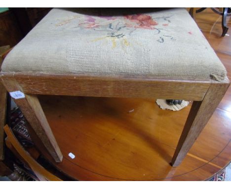 An 19th Century Oak and Tapestry Stool, with a needlework upholstered top, shell carved cabriole legs and claw and ball feet.