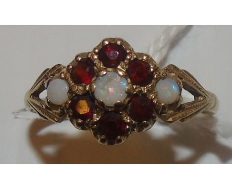 A Nine Carat Opal and Garnet Cluster Ring.