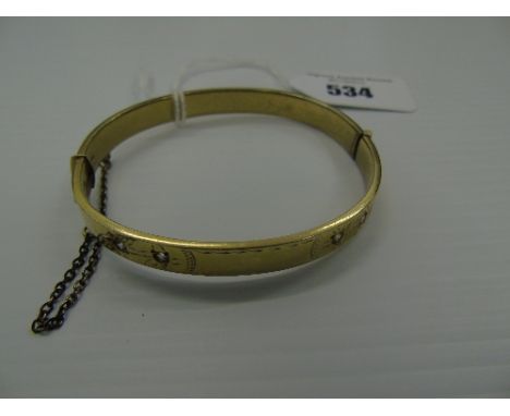 A Nine Carat Gold Bangle, set with clear stones, 23 grams.