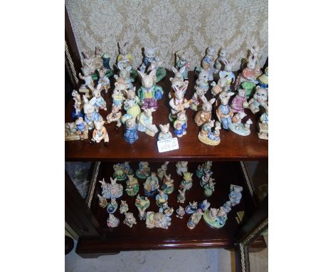 A Large Collection of Miniature Ceramic Bear & Hare Figurines (2 shelves).