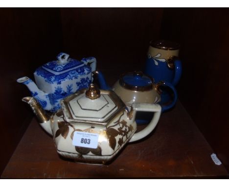 A Masons Chinoiserie Tea Pot, a Blue Stoneware Teapot and Matching Water Jug, c. 1920 and a golf blush squat example.