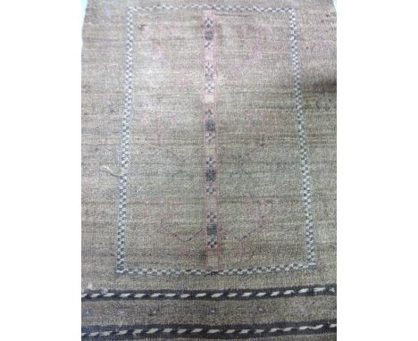 A Kurdish Rug with a light brown field, 112 x 73 cm. 