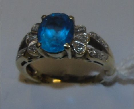 A Nine Carat Diamond and Blue Topaz Cluster Ring.