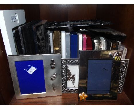 A Shelf of Decorative and Plated Picture Frames.