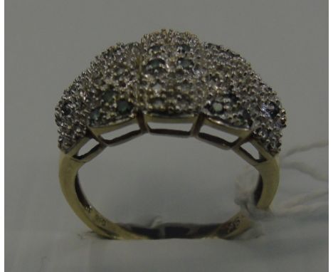 A Nine Carat Diamond and Emerald Cluster Ring.