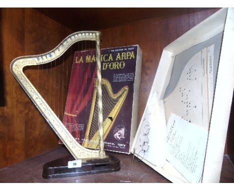 A Gold Coloured Harp - 'La Magica Arpa d'Oro,' contained in an original cardboard box.