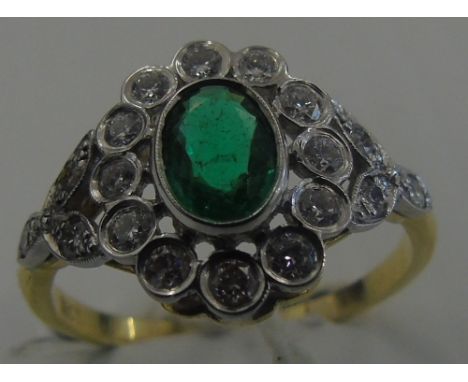 An 18ct Gold Emerald & Diamond Cluster Ring, the oval-shape emerald collet, within a brilliant-cut diamond surround, brillian