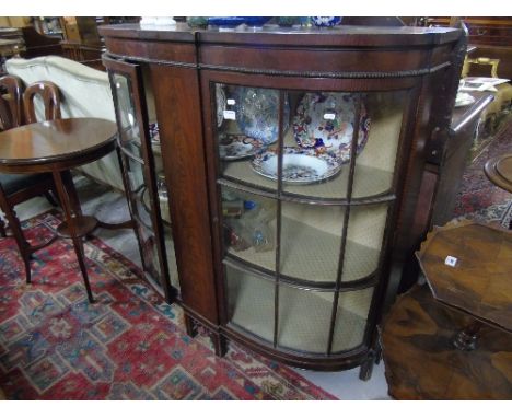 An Early 20th Bow Fronted Display Cabinet, with two bow astragal doors.