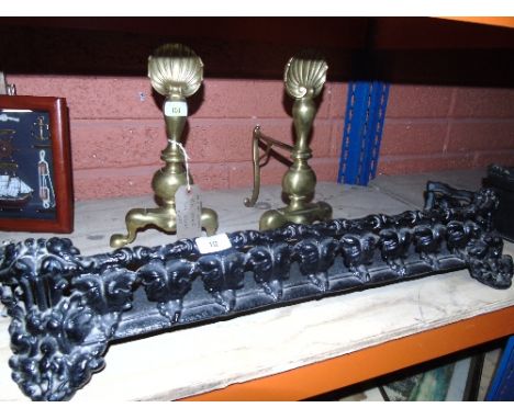A Black Cast Iron Fender, together with a Pair of Art Nouveau Fire Dogs.