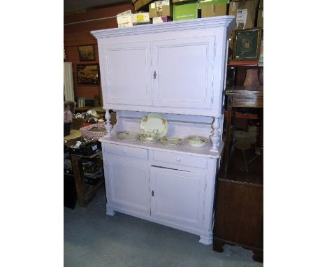 A 19th Century Painted Continental Pine Buffet, the upper section enclosed by a pair of panelled doors raised on turned colum