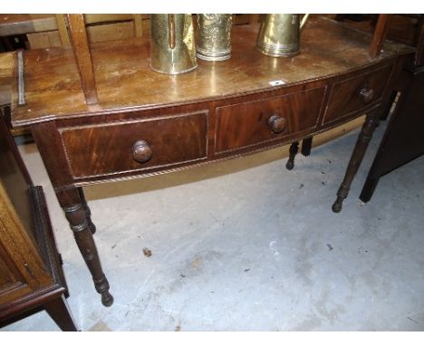 A 19th Century Bow Fronted Side Table, having three freeze drawers, lacking gallery.