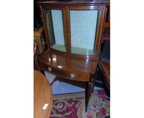 An Edwardian Bow Fronted Display Cabinet, the glazed top having a single glass shelf, above single drawer with inlaid design,