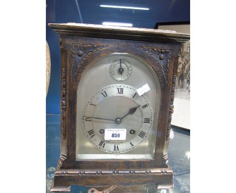 An Early 20th Century Oak Cased Mantel Clock, the silvered dial with Roman numerals and subsidiary slow/fast dial.