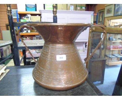 A Hammered and Embossed Twin Handled Copper Urn.