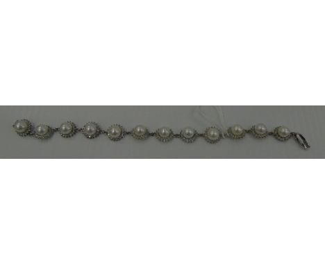 A White Gold Diamond and Pearl Bracelet.