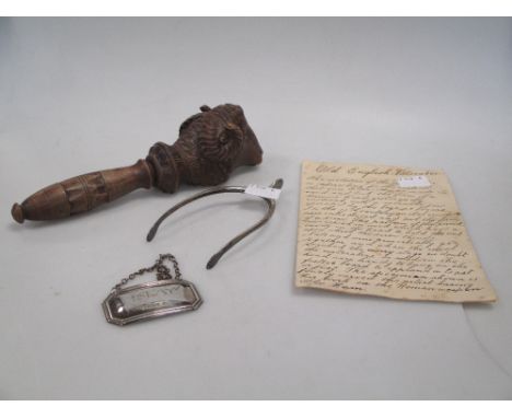 A pair of silver wishbone sugar nips, a decanter label and a rams head nut cracker (3)  