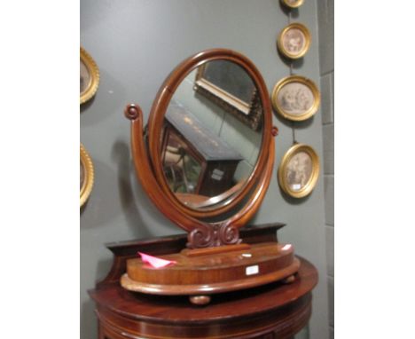A Victorian mahogany oval swing frame mirror  