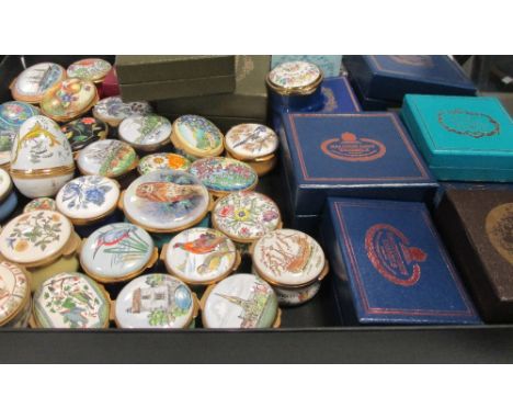 A collection of approximately 40 enamel pill boxes by Halcyon Days, Crummles and others, largely without boxes, together with