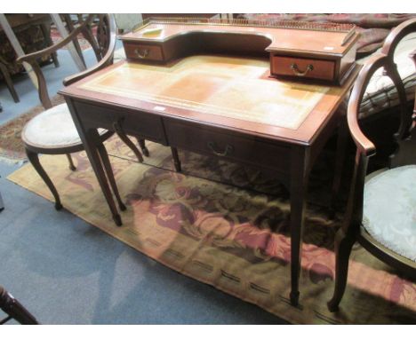 A late Victorian mahogany and crossbanded desk, with brass gallery to the superstructure, fitted two drawers, on tapering squ