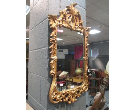 A modern ornate gilt framed mirror, 87 x 44cm  