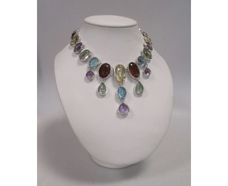 A multi gemset necklace, the graduated oval, round, cushion and pear shaped stones comprising of topaz, citrine, smokey quart