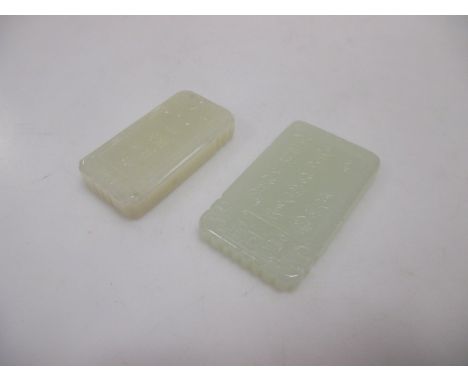 Two Chinese jade rectangular pendants carved on one side with a child, one with a boat and the other with lotus  