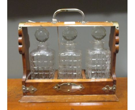 An early 20th century oak tantalus  