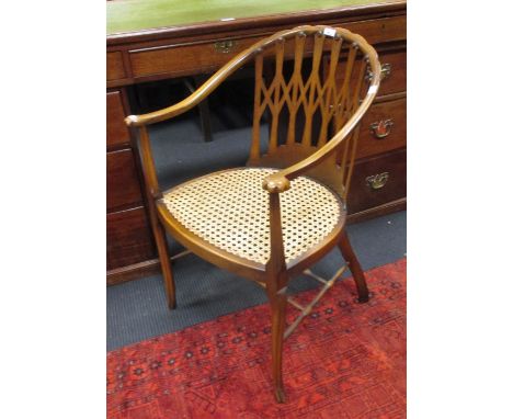 A horseshoe shaped cane seated armchair, and a carved gilt wood wall mirror (2)  
