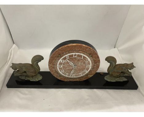 A CONTINENTAL ART DECO CLOCK ON A PLINTH WITH SQUIRREL GARNITURES 23" WIDE 