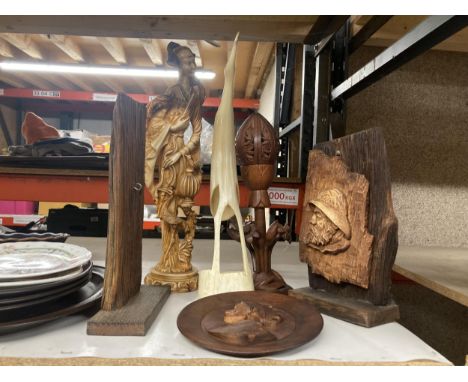 A WOODEN CARVED PLAQUE OF A FISHERMAN ON A STAND, WOODEN LOTUS LAMP, A LARGE HORN BIRD, AN ORIENTAL LADY PLUS A CARVED WOODEN