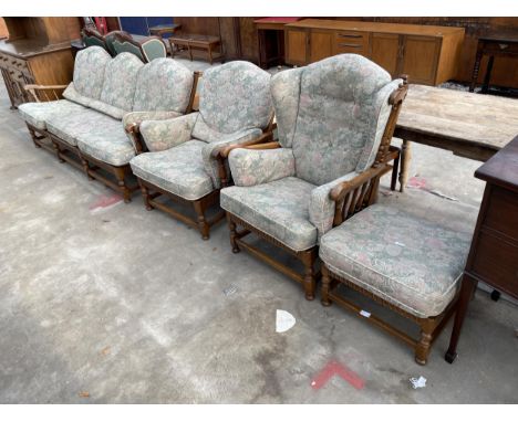 AN ERCOL ELM FOUR PIECE LOUNGE SUITE COMPRISING THREE SEATER SETTEE, TWO EASY CHAIRS AND A STOOL 