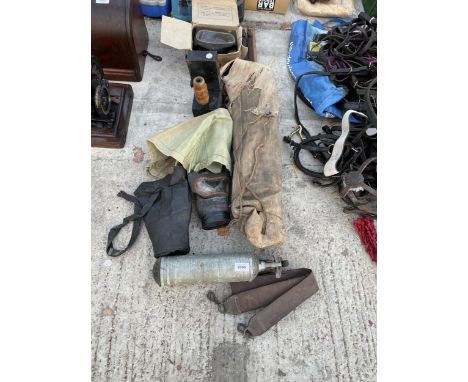 AN ASSORTMENT OF VINTAGE MILITARY ITEMS TO INCLUDE HIS AND HERS CIVILIAN GAS MASKS, AN OFFICERS FOLDABLE SINK, SIGNALLING LAM