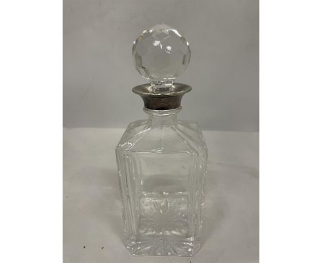 A CUT GLASS DECANTER (STOPPER A/F) WITH A TESTED TO SILVER COLLAR 