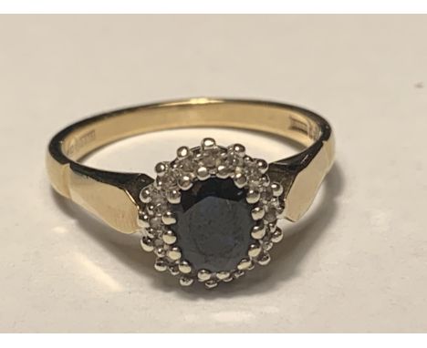 A 9 CARAT GOLD RING WITH CENTRE SAPPHIRE SURROUNDED BY DIAMONDS SIZE M 