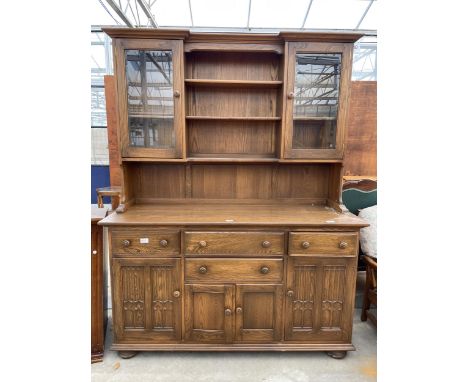 AN ERCOL ELM DRESSER WITH FOUR DRAWERS AND CUPBOARDS TO THE BASE, THE UPPER PORTION HAVING SHELVES AND GLAZED CUPBOARDS, 62" 