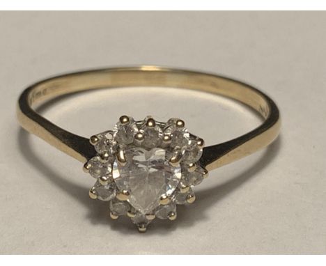 A 9 CARAT GOLD RING WITH A CENTRE HEART DESIGN CUBIC ZIRCONIA SURROUNDED BY THE SAME STONE SIZE T/U 