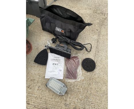 AN AS NEW TACK LIFE ELECTRIC SANDER WITH ATTATCHMENTS AND CARRY BAG 