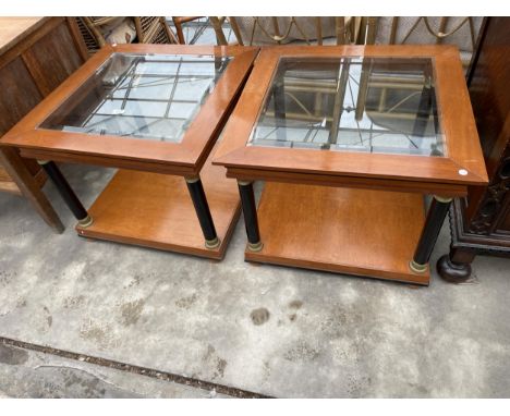 A PAIR OF SELVA STYLE INTERNATIONAL (NO.3) TWO TIER LAMP TABLES WITH INSET GLASS TOPS ON TURNED EBONISED SUPPORTS, 27.5" SQUA