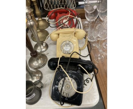 THREE VINTAGE ROTARY DIAL TELEPHONES IN BLACK, CREAM AND RED 