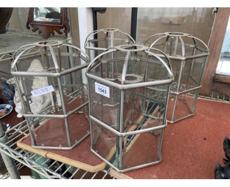 A SET OF FOUR DECORATIVE GLASS AND METAL LIGHT SHADES 