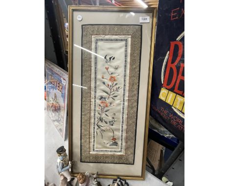 A FRAMED ORIENTAL NEEDLEWORK ON SILK PANEL 