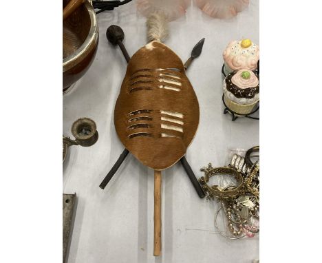 A VINTAGE ANIMAL HIDE SHIELD WITH KNOBKERRIE AND SPEAR 