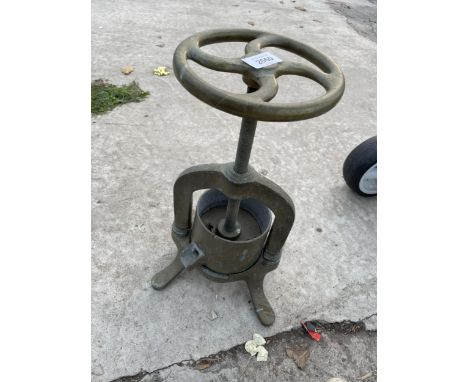 A VINTAGE BRASS FRUIT PRESS 