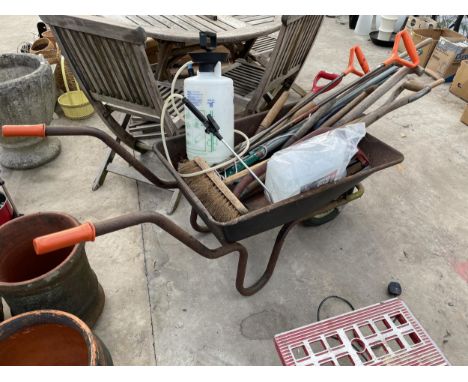 A METAL WHEEL BARROW CONTAINING AN ASSORTMENT OF GARDEN TOOLS TO INCLUDE SPADES, FORKS AND BRUSHES ETC 