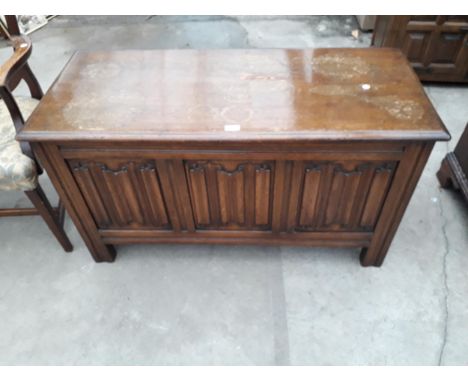 A REPRODUCTION OAK BLANKET CHEST WITH THREE PANEL LINEN FOLD FRONT, 45" WIDE 