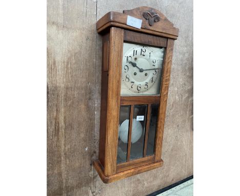 AN EARLY 20TH CENTURY BEECH EIGHT-DAY WALL CLOCK 