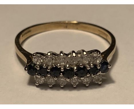 A 9 CARAT GOLD RING WITH SEVEN IN LINE SAPPHIRES WITH A LINE OF SIX CUBIC ZIRCONIAS EACH SIDE SIZE Q/R 