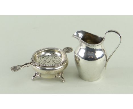 EDWARDIAN SILVER MILK JUG &amp; GEORGE V TEA STRAINER, jug with reeded strap handle, strainer with shell handles and matching
